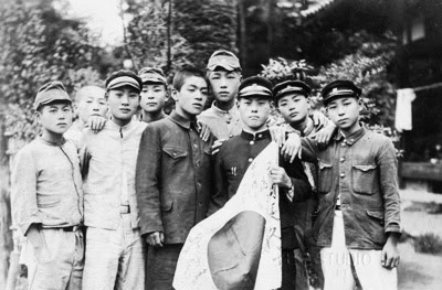 When Japanese men were drafted into service, their family and friends gathered to show their support. A small Japanese flag would be signed by the family with black ink. The flag was folded and carried securely beneath their clothing into war.